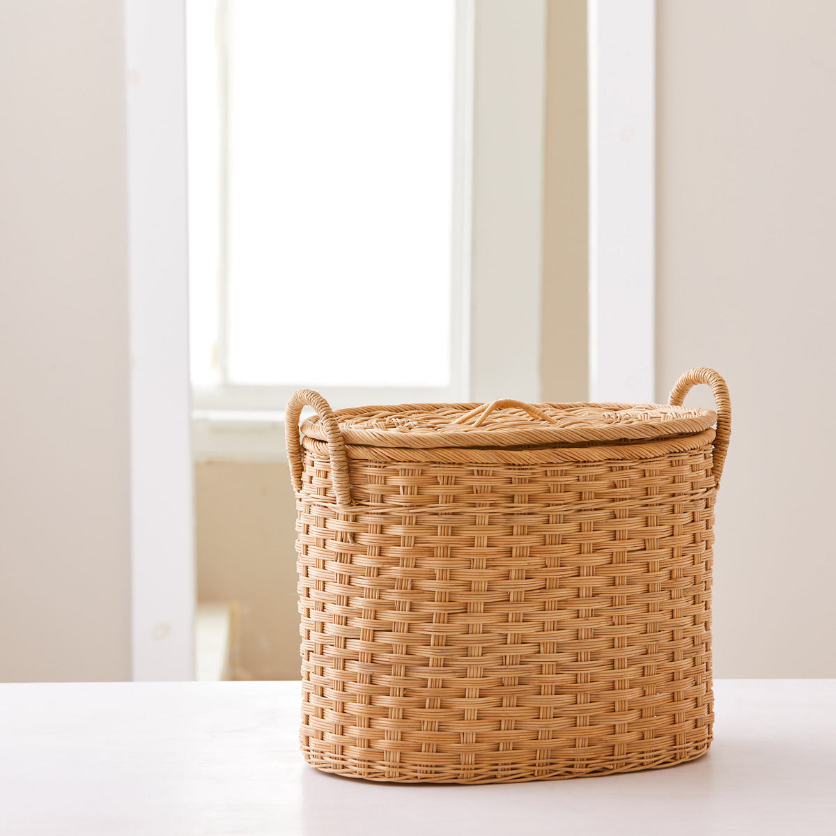 Oval rattan storage basket. Unique storage baskets with lids and handles. 5 sizes. Small basket shown. Great basket for storage. XL, L, M, S, XS.