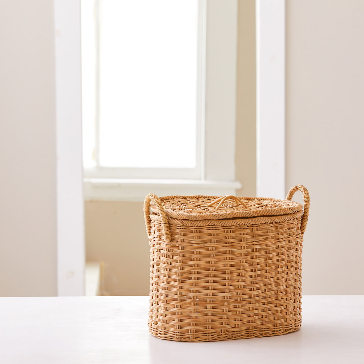 Oval rattan storage basket. Unique storage baskets with lids and handles. 5 sizes. Extra Small basket shown. Great basket for storage. XL, L, M, S, XS.