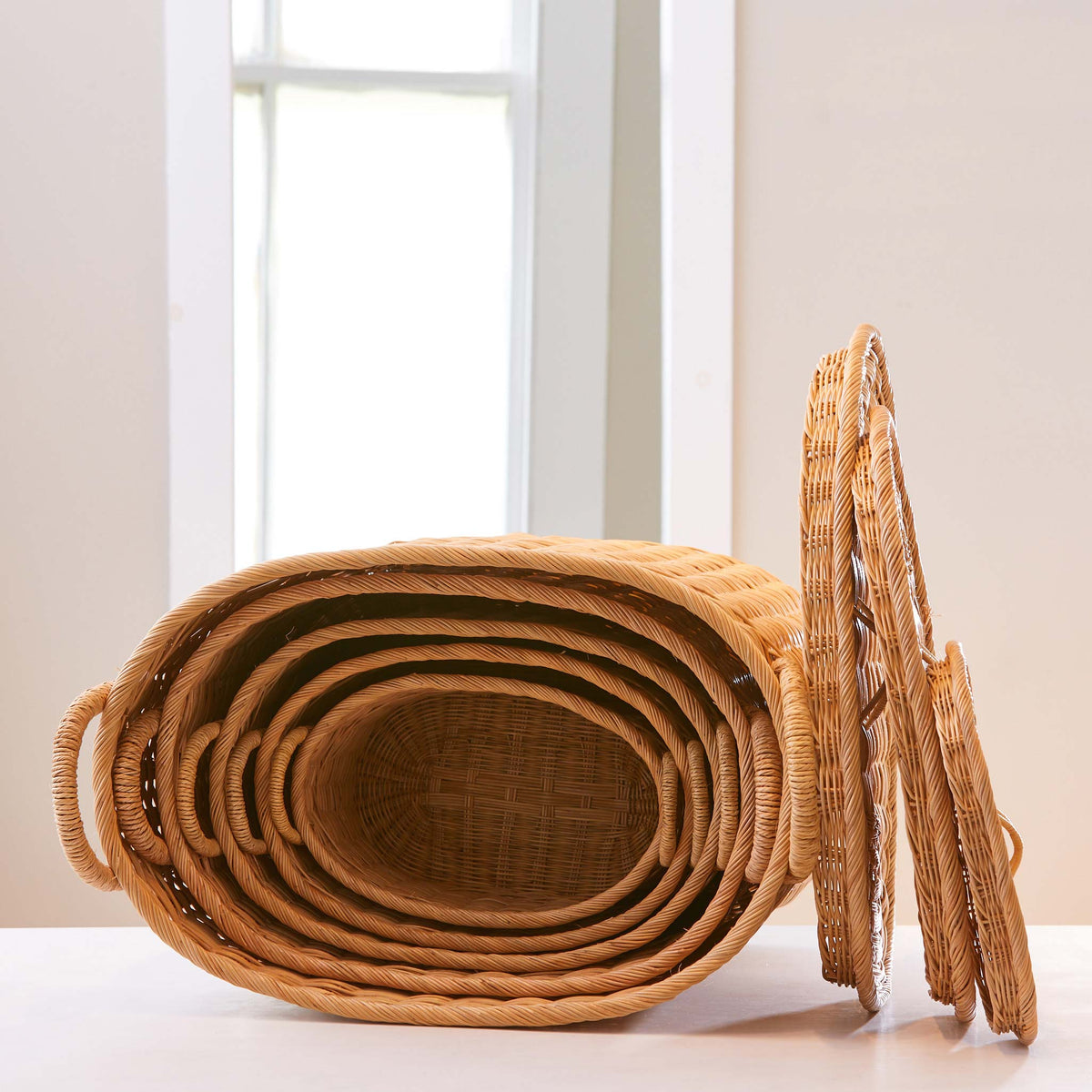 Oval rattan storage baskets. Unique storage baskets with lids and handles. 5 sizes from large storage baskets to small. Perfect baskets for shelves.