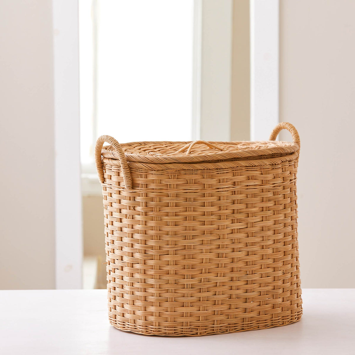 Oval rattan storage basket. Unique storage baskets with lids and handles. 5 sizes. Medium basket shown. Great basket for storage. XL, L, M, S, XS.